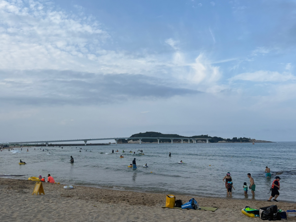 Families and tourists swimming and playing at Goseong Beach"