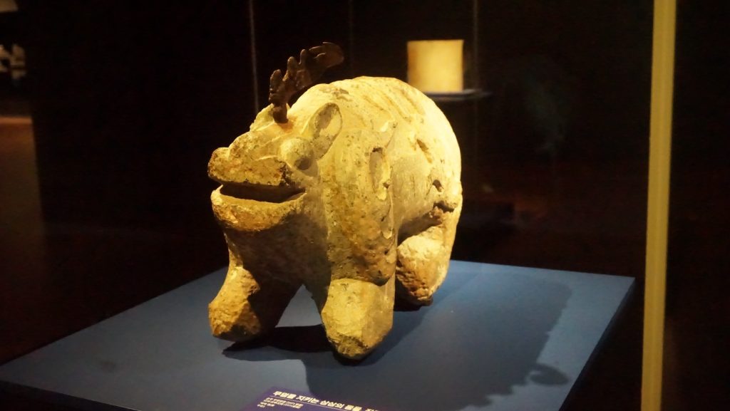Small stone animal sculpture displayed in the Baekje exhibition at National Gongju Museum.
