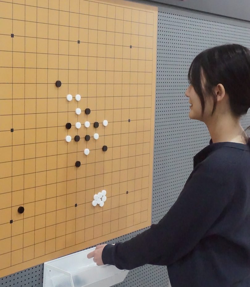 Visitor playing on an interactive baduk (Go) board at National Gongju Museum.